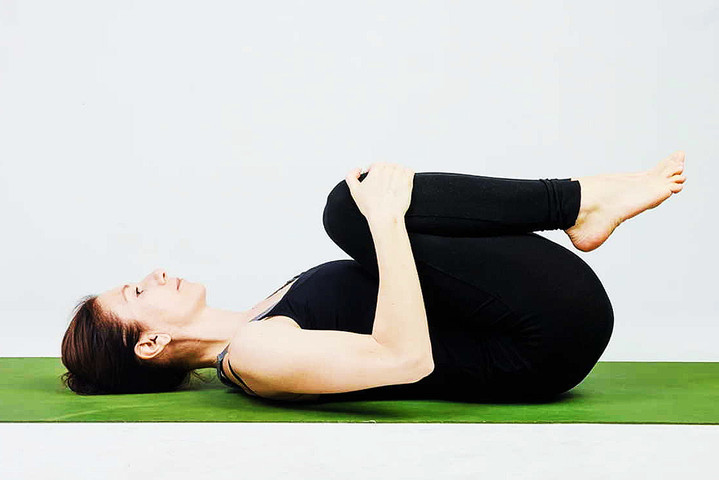 Yoga Asanas for Losing weight: 8-	Supta pawan muktasan or the leg lock-wind relieving pose